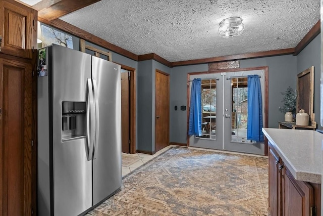 kitchen with brown cabinets, light countertops, french doors, a textured ceiling, and stainless steel refrigerator with ice dispenser