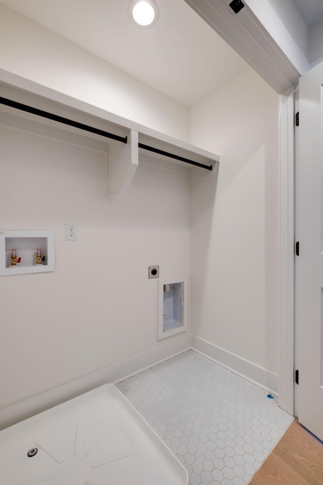 laundry room with electric dryer hookup, hookup for a washing machine, laundry area, and baseboards