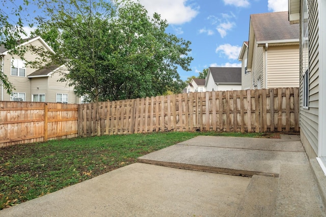 fenced backyard with a patio area