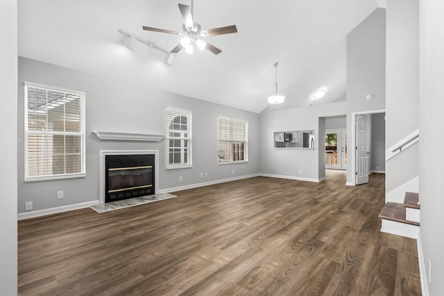 unfurnished living room featuring ceiling fan, a fireplace with flush hearth, dark wood-style floors, stairs, and baseboards