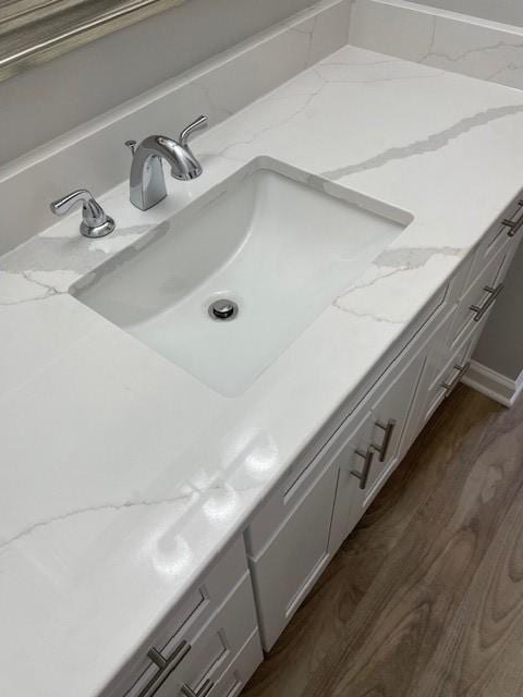 bathroom view of a sink and wood finished floors
