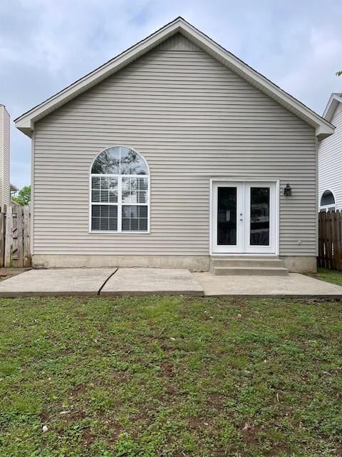 rear view of property featuring a patio area and french doors