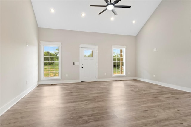 unfurnished living room with light wood finished floors, a ceiling fan, baseboards, and recessed lighting