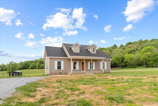 cape cod-style house featuring crawl space, covered porch, and gravel driveway