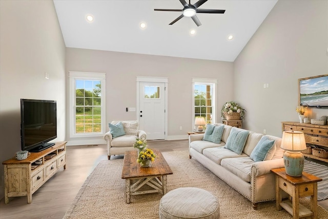 living area with recessed lighting, light wood-style flooring, high vaulted ceiling, and ceiling fan