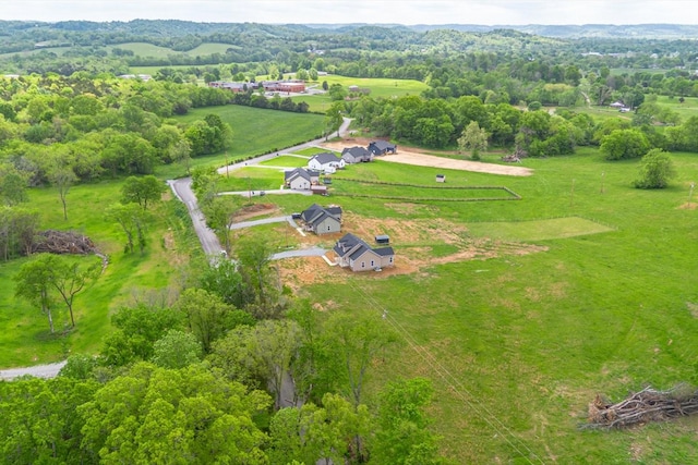 birds eye view of property with a rural view
