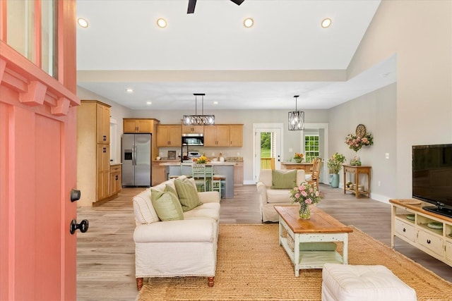 living room with recessed lighting, light wood finished floors, and baseboards