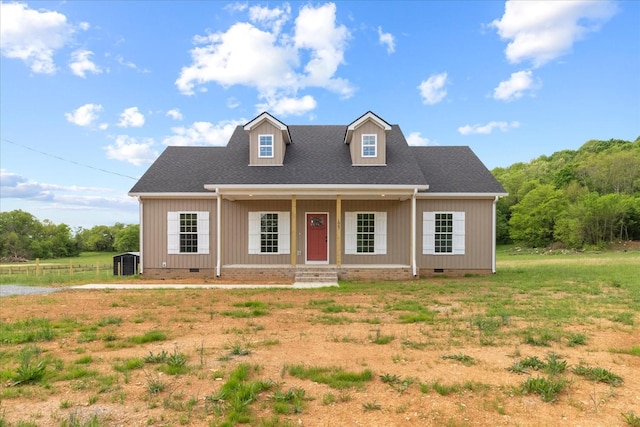 new england style home featuring crawl space, a shingled roof, covered porch, and central AC