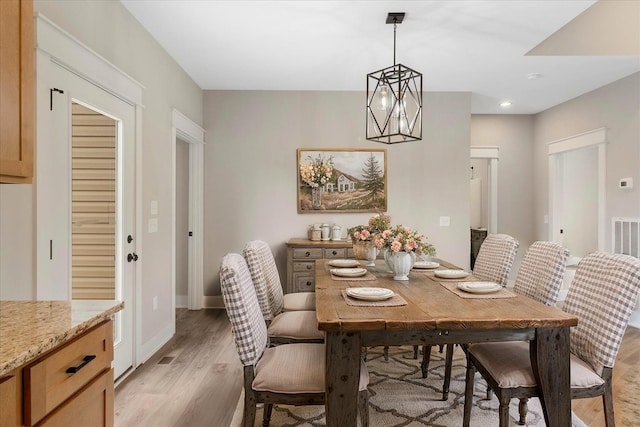 dining room with baseboards, recessed lighting, and light wood-style floors