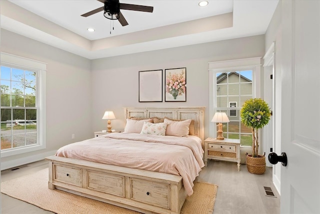 bedroom featuring wood finished floors, visible vents, and recessed lighting