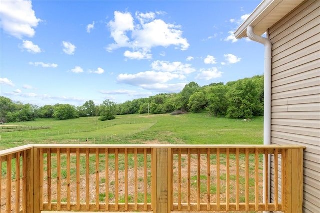 view of yard with a rural view and a deck