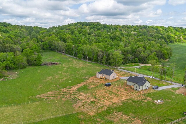 birds eye view of property featuring a wooded view