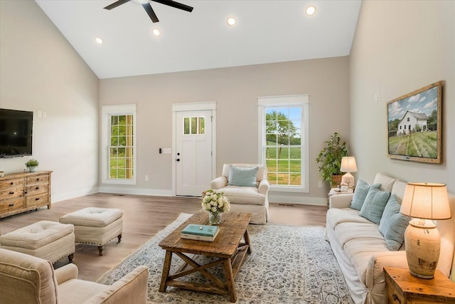 living area featuring high vaulted ceiling, a ceiling fan, light wood finished floors, baseboards, and recessed lighting
