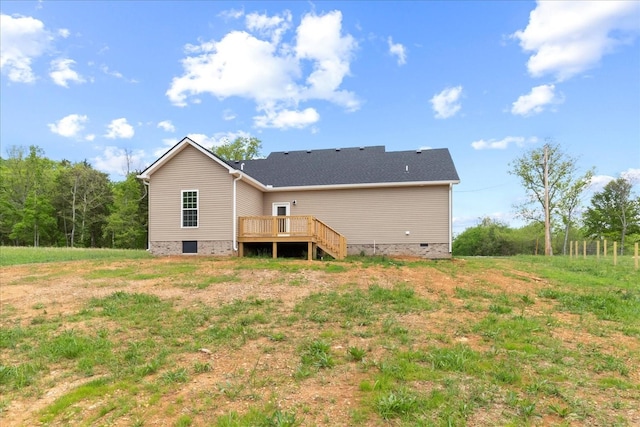 rear view of house featuring crawl space and a deck