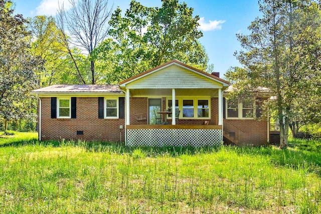 view of front of house with crawl space, covered porch, and brick siding