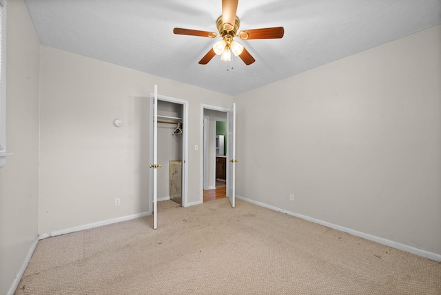 unfurnished bedroom with ceiling fan, baseboards, a closet, and carpet
