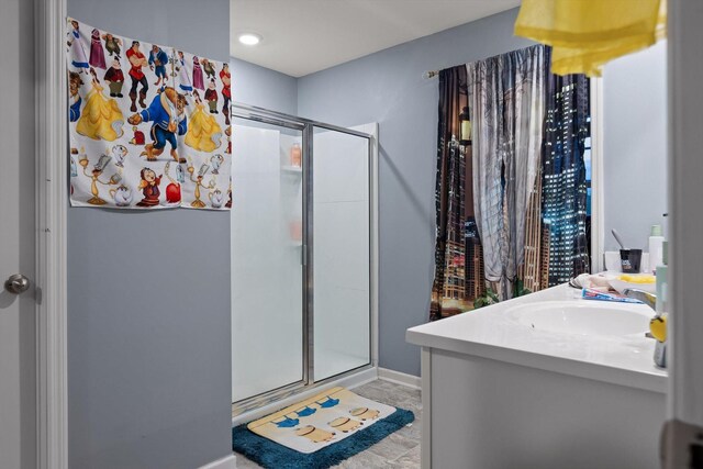 full bathroom with a shower stall, vanity, and baseboards