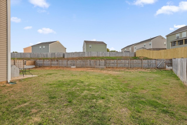 view of yard featuring a residential view and a fenced backyard