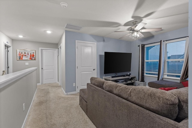 living area with light carpet, visible vents, baseboards, recessed lighting, and ceiling fan