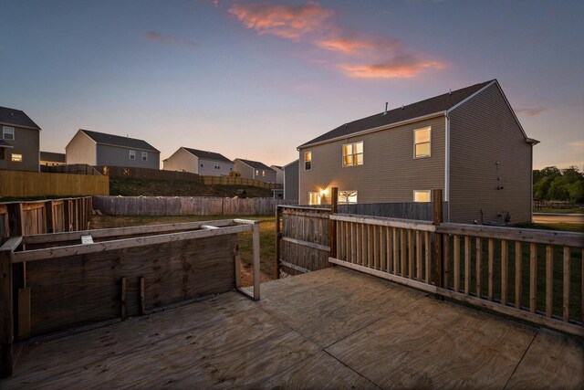 wooden terrace featuring a fenced backyard