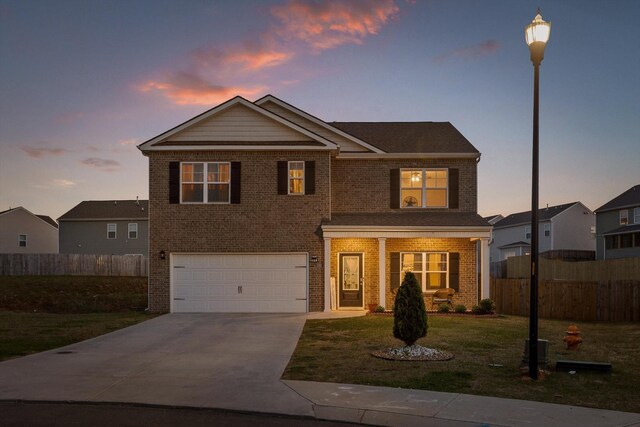 view of front facade featuring an attached garage, brick siding, and a front yard