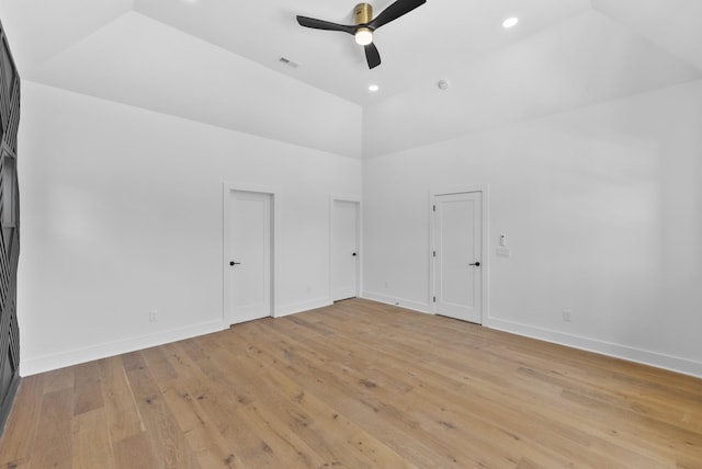 spare room with light wood finished floors, baseboards, a ceiling fan, and high vaulted ceiling
