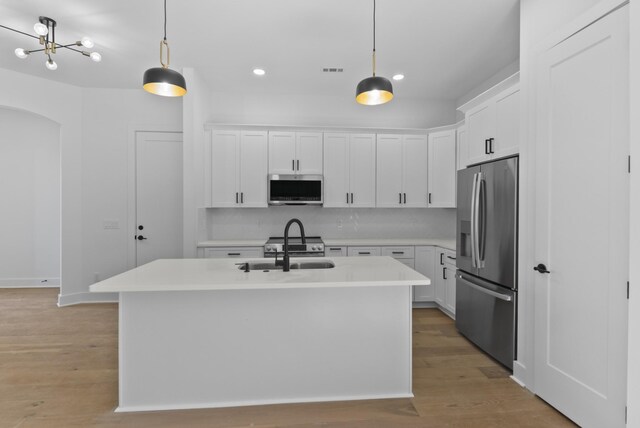 kitchen featuring stainless steel appliances, light countertops, recessed lighting, and white cabinetry