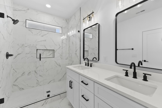 full bathroom featuring visible vents, marble finish floor, a marble finish shower, and a sink