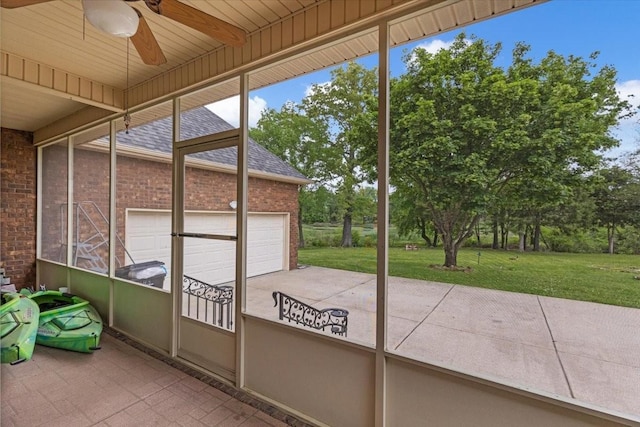 unfurnished sunroom with ceiling fan