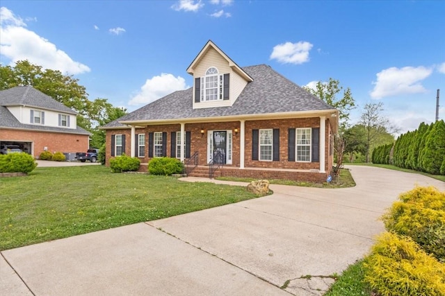 view of front of property with concrete driveway, roof with shingles, covered porch, brick siding, and a front lawn