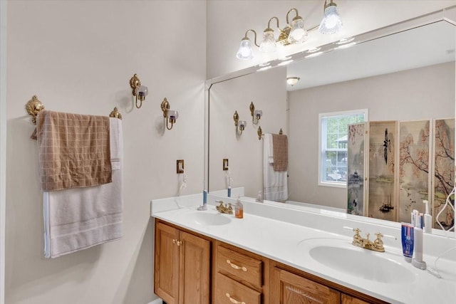 full bathroom featuring walk in shower, double vanity, and a sink