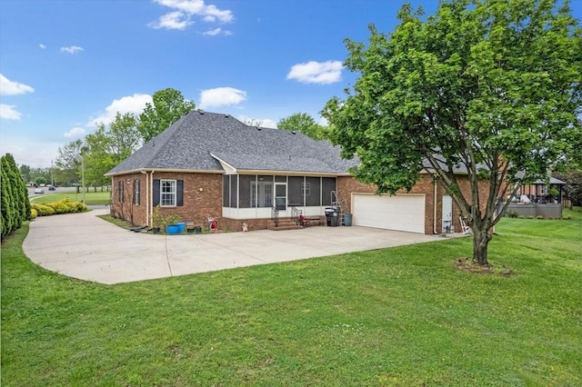view of front of property with a sunroom, a front yard, brick siding, driveway, and roof with shingles