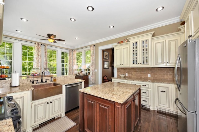 23475 Slate Rd, Athens, AL 35614 - kitchen featuring ceiling fan, a wealth of natural light, cream cabinetry, and stainless steel appliances