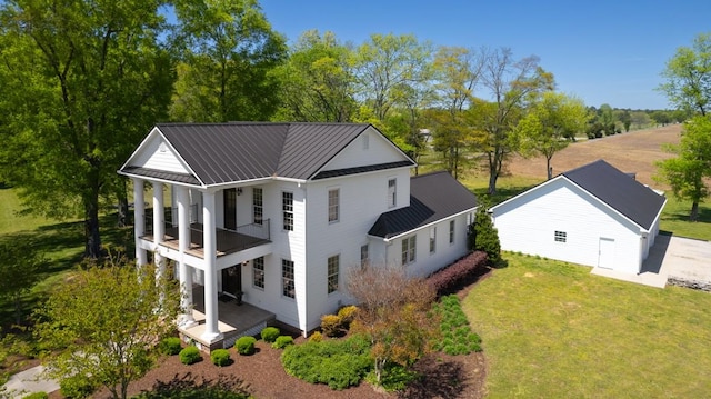 23475 Slate Rd, Athens, AL 35614 - back of property with metal roof, a lawn, a standing seam roof, and a balcony