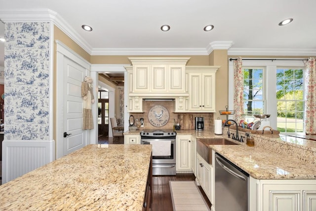 23475 Slate Rd, Athens, AL 35614 - kitchen featuring stainless steel appliances, a sink, cream cabinetry, light stone counters, and crown molding