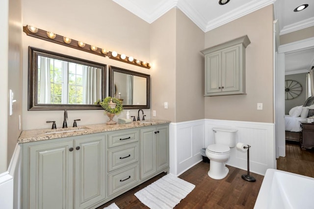 23475 Slate Rd, Athens, AL 35614 - bathroom with a sink, toilet, wainscoting, wood finished floors, and ornamental molding