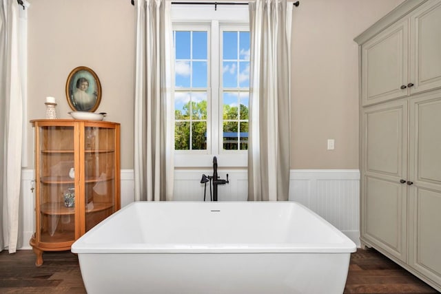 23475 Slate Rd, Athens, AL 35614 - full bath with wainscoting, a decorative wall, a freestanding tub, and wood finished floors