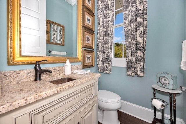 23475 Slate Rd, Athens, AL 35614 - bathroom with baseboards, wood finished floors, vanity, and toilet