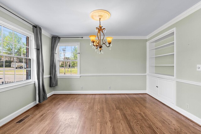 2418 Abbott Martin Rd, Nashville, TN 37215 - spare room with a chandelier, wood finished floors, visible vents, and ornamental molding