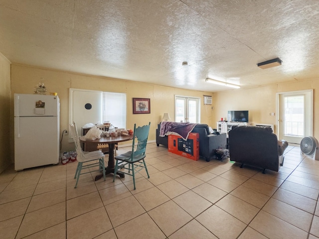 dining area with a textured ceiling and light tile patterned floors