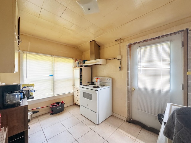 kitchen with a healthy amount of sunlight, white electric stove, and light tile patterned flooring