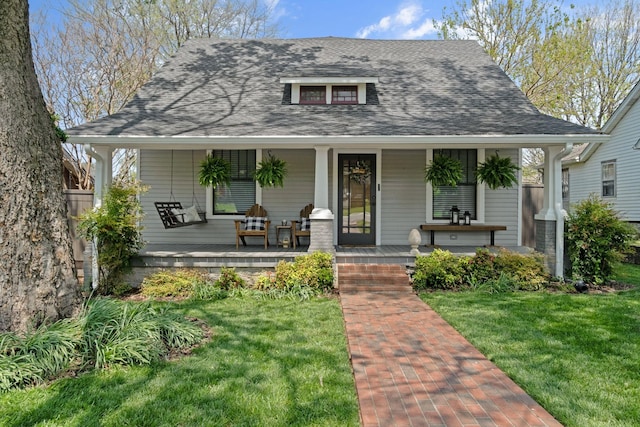 4306 Idaho Ave, Nashville, TN 37209 - bungalow-style home with covered porch, a front yard, and roof with shingles