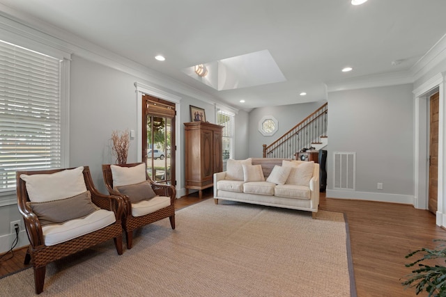 4306 Idaho Ave, Nashville, TN 37209 - living room featuring wood finished floors, visible vents, stairs, and ornamental molding