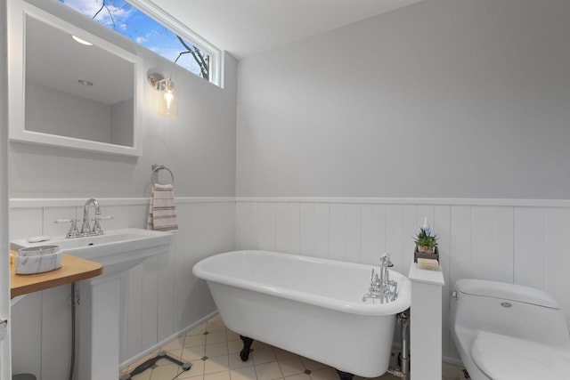 4306 Idaho Ave, Nashville, TN 37209 - full bathroom featuring tile patterned flooring, a soaking tub, toilet, and wainscoting