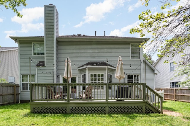 back of property featuring a wooden deck and a chimney