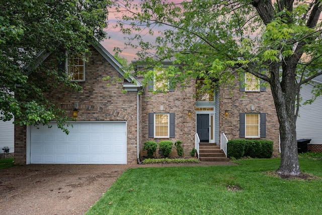 view of front facade featuring driveway, a front lawn, an attached garage, and brick siding