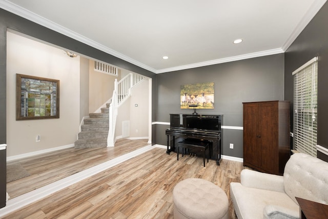 sitting room with stairway, baseboards, ornamental molding, wood finished floors, and recessed lighting