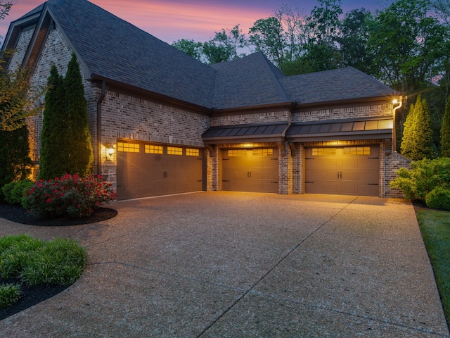 1320 Ashby Valley Ln, Arrington, TN 37014 - view of front facade featuring brick siding, a shingled roof, driveway, and an attached garage