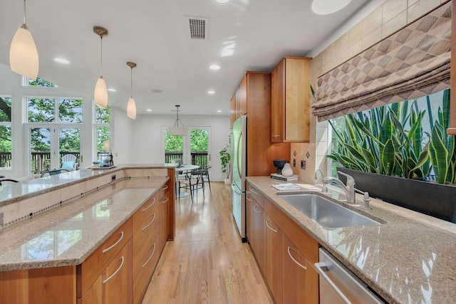 635 Harpeth Trace Dr, Nashville, TN 37221 - kitchen with visible vents, pendant lighting, a sink, freestanding refrigerator, and light wood finished floors