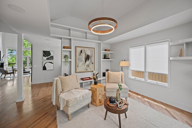 635 Harpeth Trace Dr, Nashville, TN 37221 - living area with a notable chandelier, built in shelves, wood finished floors, baseboards, and lofted ceiling